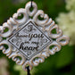 Close-up of memorial wind chime tubes engraved with “So until our heavenly reunion, I have you in my heart”